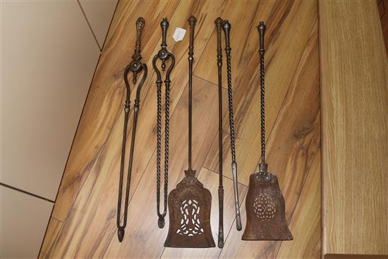 A set of three George III steel and brass fire irons and a set of three steel fire irons